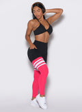 Front right side profile view of a model  looking down right wearing the Perform Thigh Highs in Black Sky color along with a black sports bra