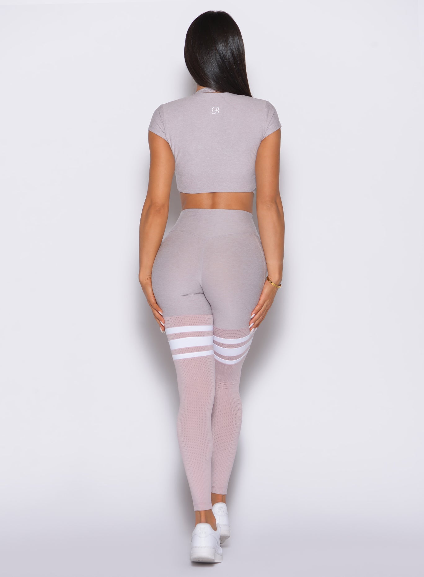 back profile of a model wearing the Perform Thigh Highs and the matching Tee in Violet Ice color
