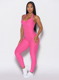 front profile picture of a model wearing our Backless Pocket Bodysuit in pink glo color