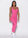 front profile view of a model facing forward wearing our Backless Pocket Bodysuit in pink glo color