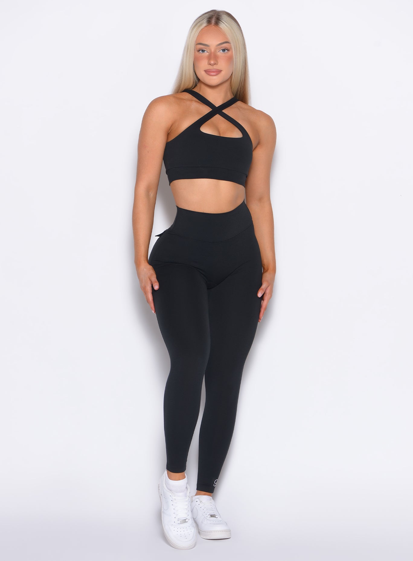 front profile view of our model in a straight pose wearing the Pocket Pop Leggings in Black color