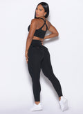 back left side profile view of our model looking over her shoulder wearing the Pocket Pop Leggings in Black color