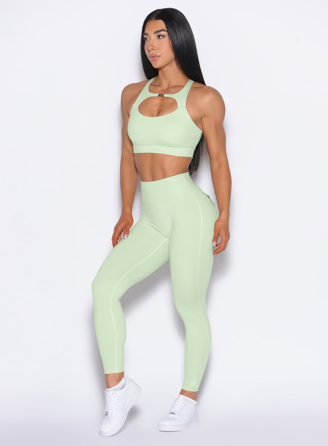 front profile view of a model wearing our Pocket Pop Leggings 2.0 in Cool Matcha color and the matching bra
