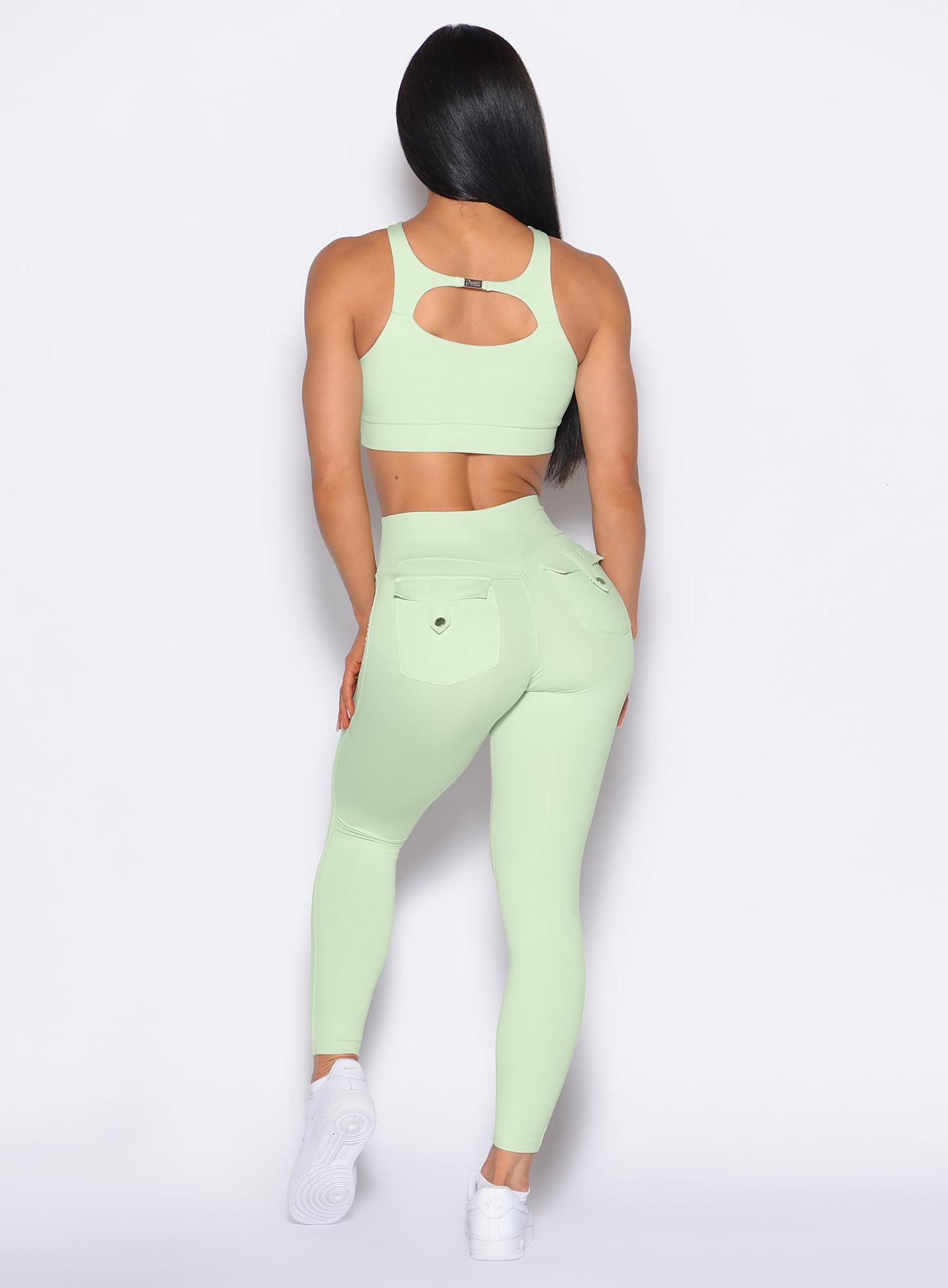 back profile of a model wearing the Pocket Pop Leggings 2.0 in Cool Matcha color and the matching bra
