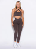 Model facing forward wearing our Pocket Pop Leggings 2.0 in Seal Brown color and the matching bra
