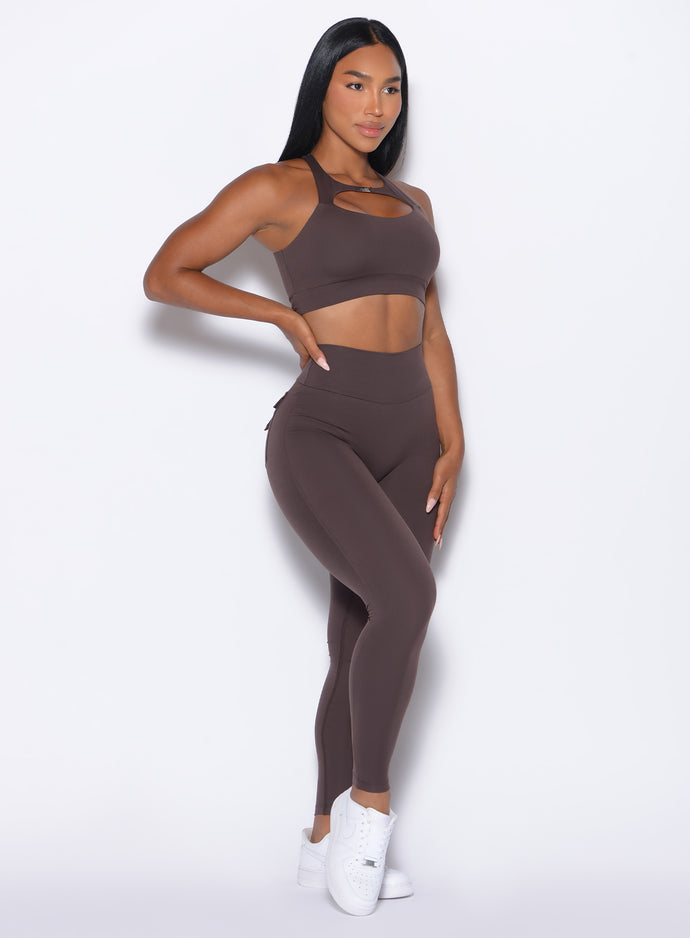 front profile picture of a model in our Pocket Pop Leggings 2.0 in Seal Brown color and the matching bra
