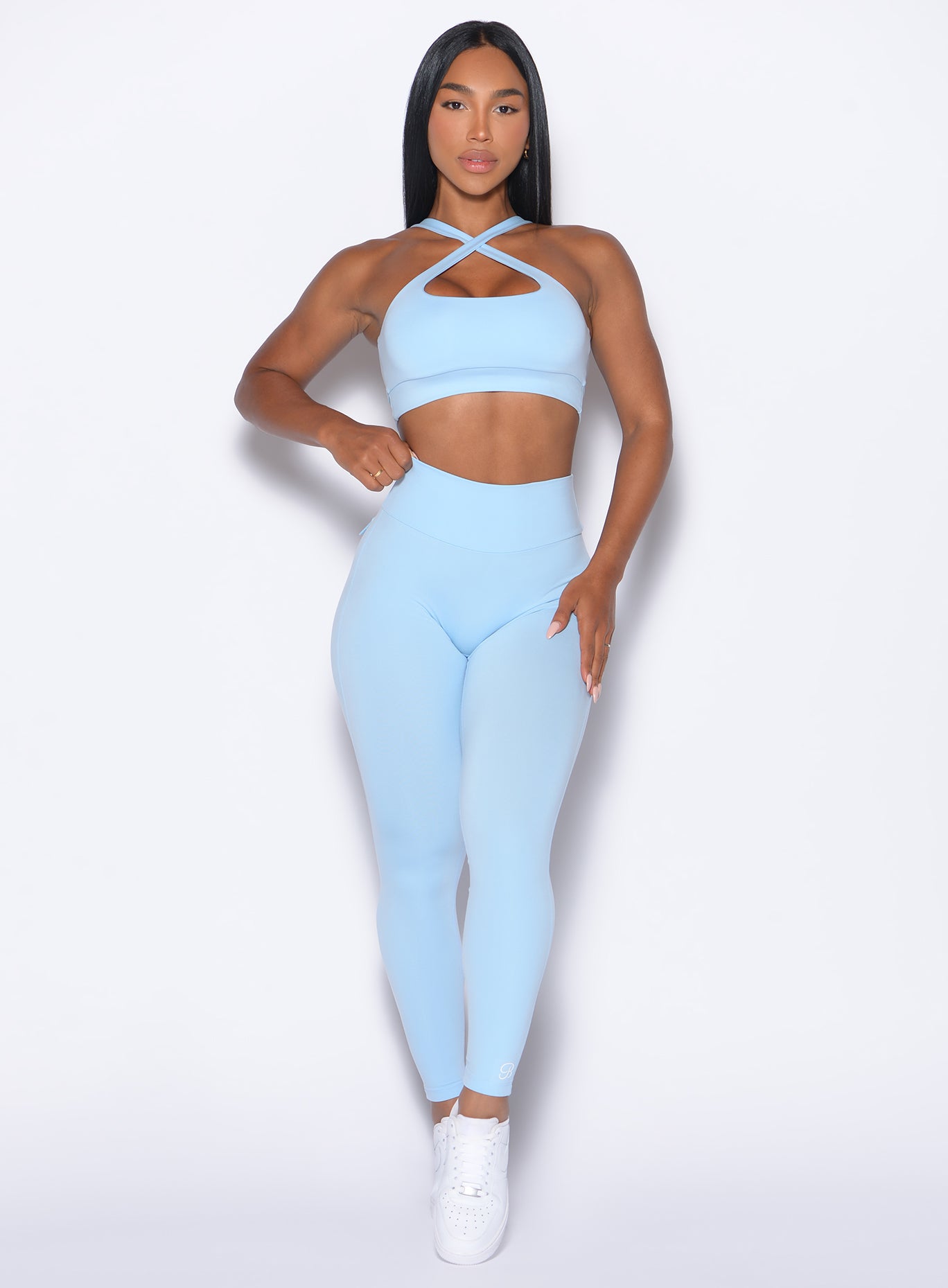 front profile view of a model wearing our Pocket Pop Leggings 2.0 in Glacial Blue color and the matching bra
