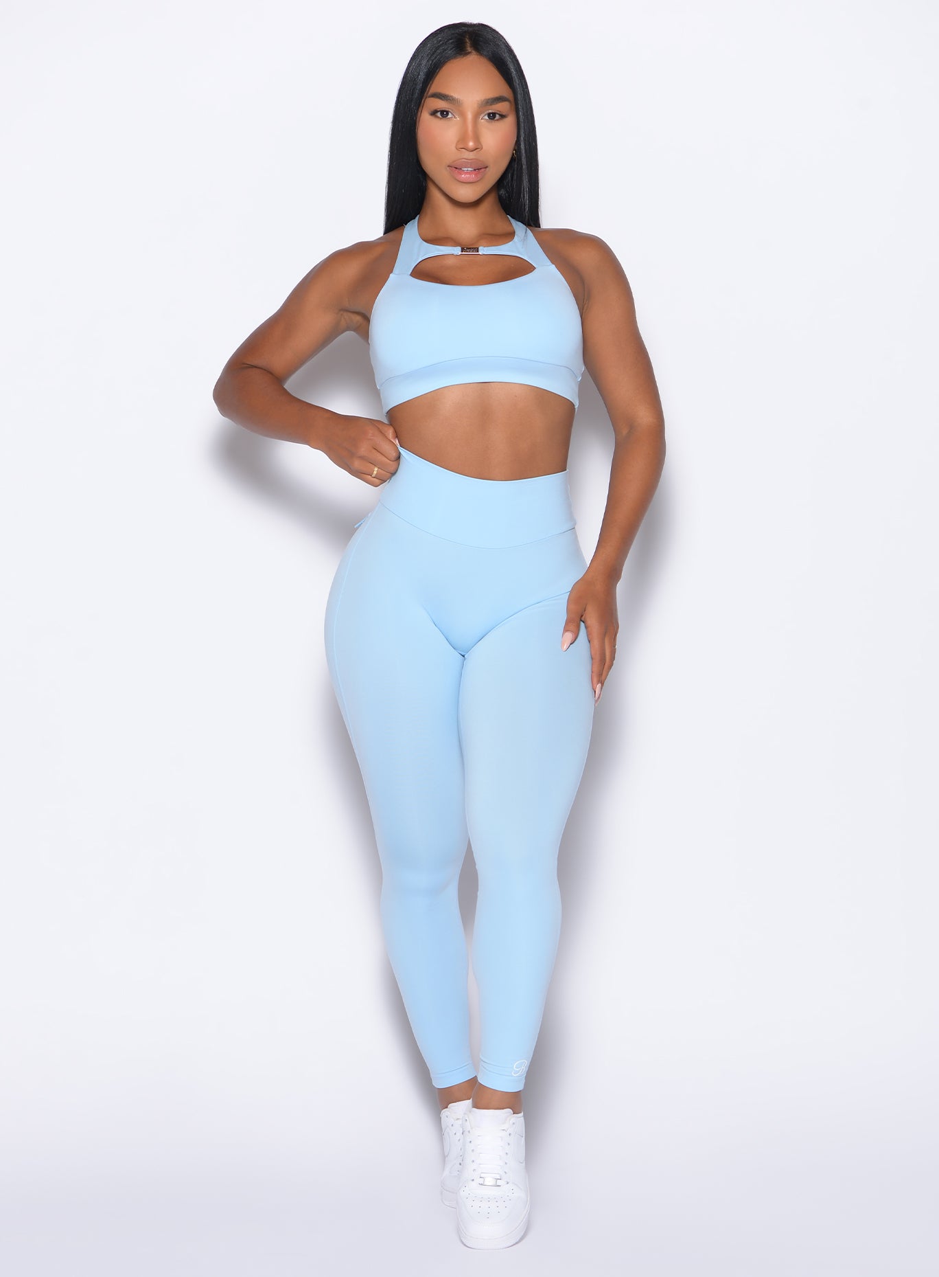 Model facing forward wearing our Pocket Pop Leggings 2.0 in Glacial Blue color and the matching bra
