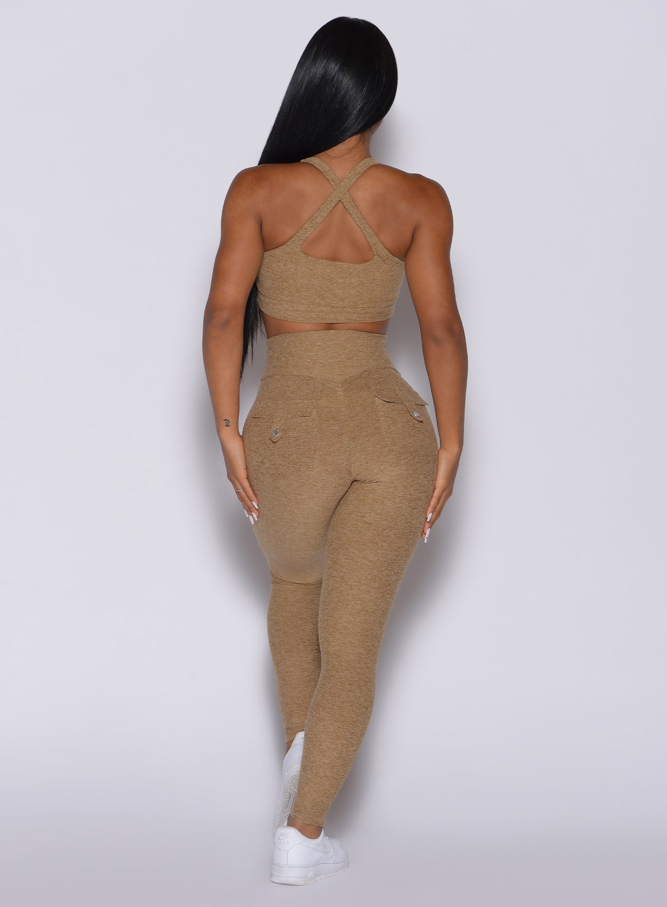 back profile picture of a model wearing our Pocket Pop Leggings in caramel color and a matching bra