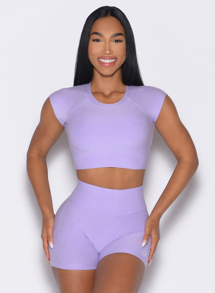 front profile view of a model with both hands on her thighs wearing the Core Strength Tee in Sugared Lilac color