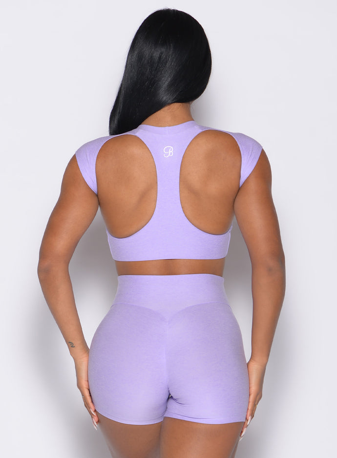 back profile view of a model wearing the Core Strength Tee in Sugared Lilac color paired with the matching shorts