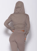 Back profile view of a model wearing our comfort rib jacket in toffee color along with a matching joggers