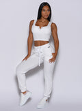 front profile view of a model facing to her left wearing our white comfort rib joggers and a matching jacket