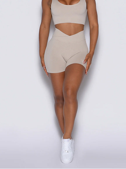 Zoomed in front view of model wearing tan activewear set