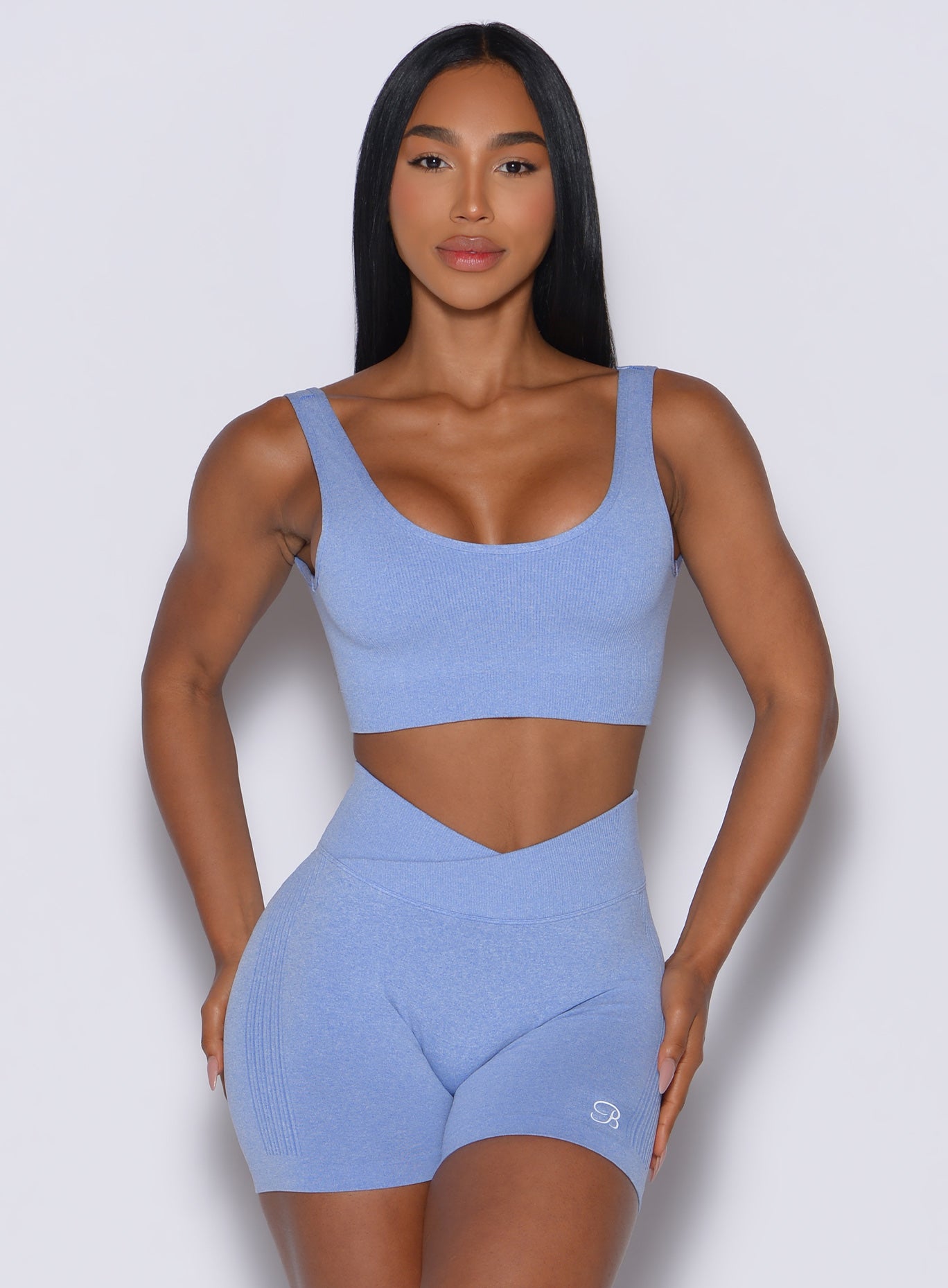 Model facing forward wearing our Seamless Scoop Bra and the matching shorts in Sky color