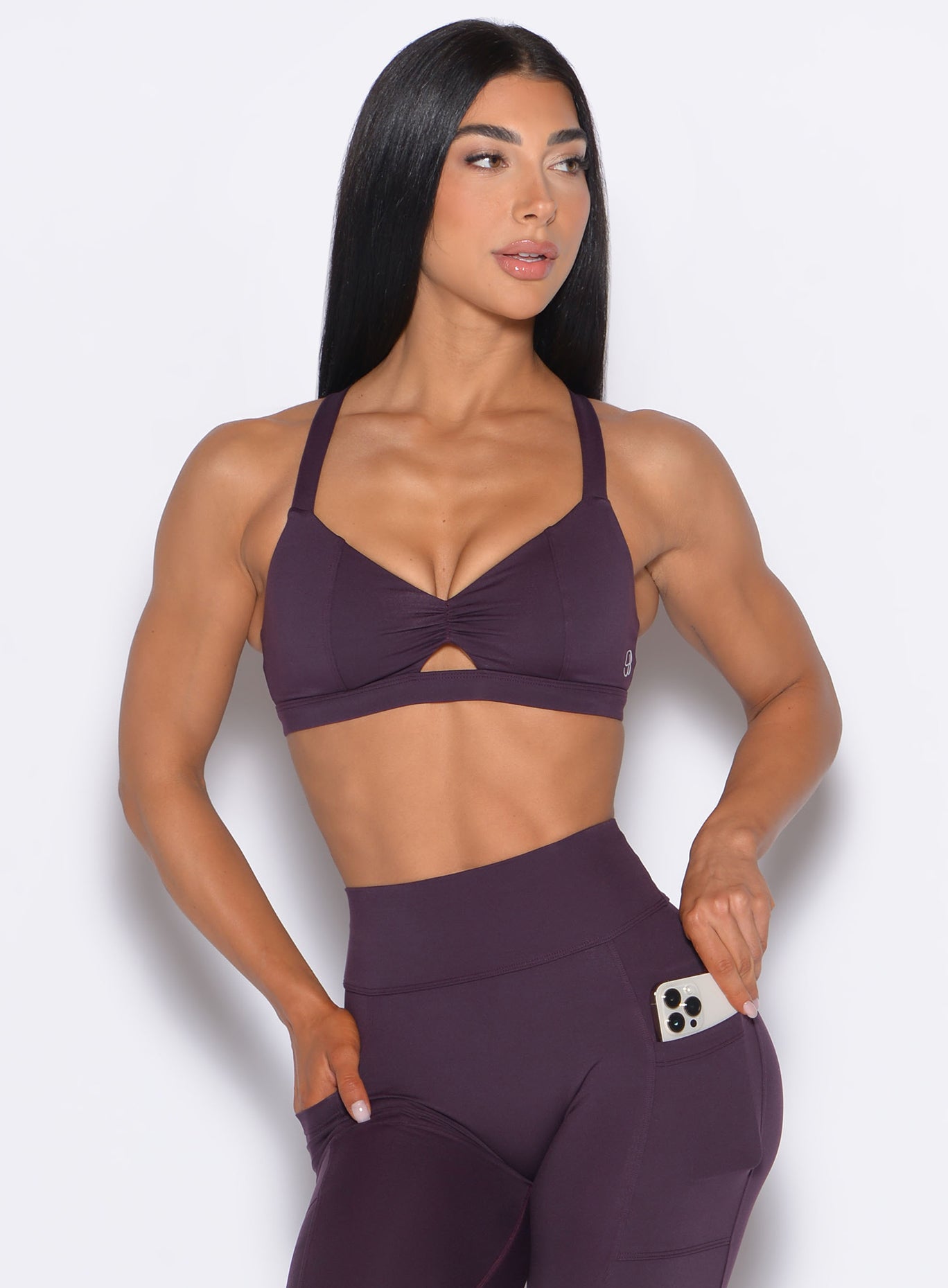 front profile view of our model looking to the left wearing the Sweetheart Sports Bra in Plum Noir color