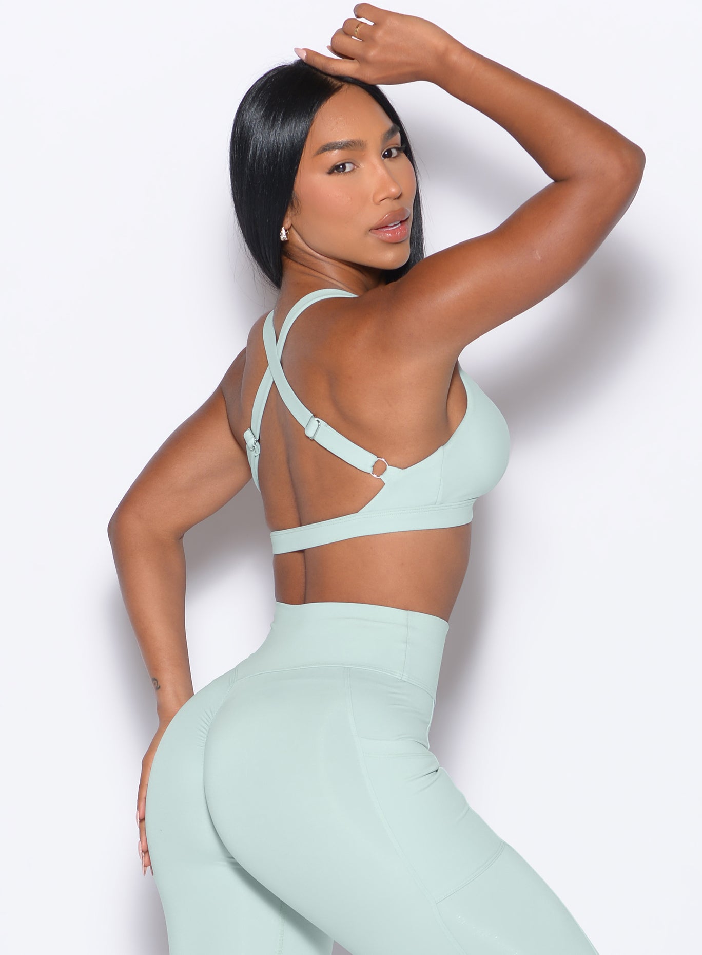 right side profile view of our model wearing the Sweetheart Sports Bra in Mist color