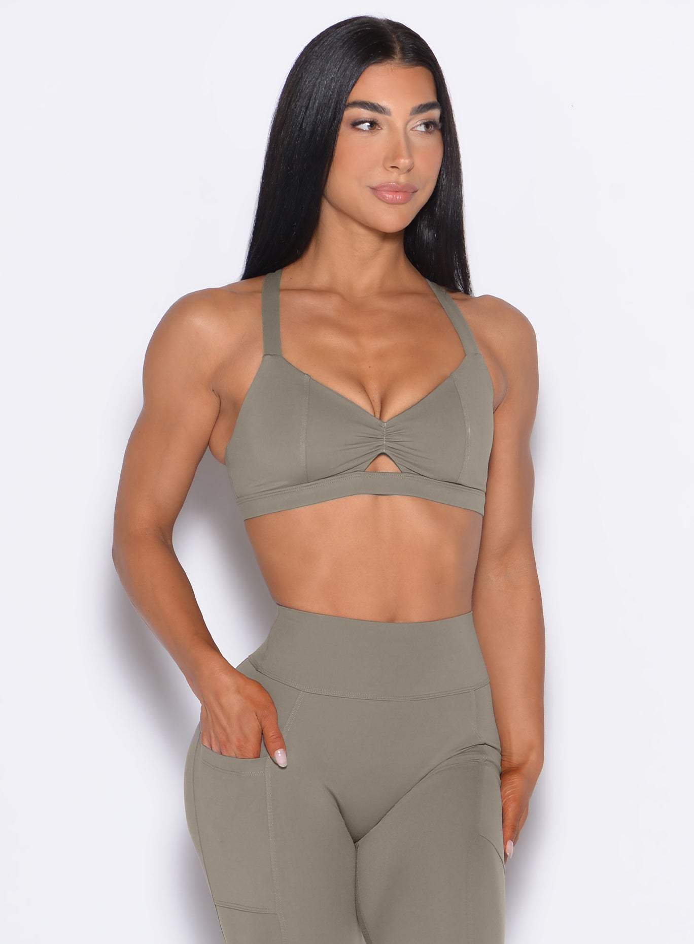 front profile view of our model looking to the left wearing the Sweetheart Sports Bra in Stone color