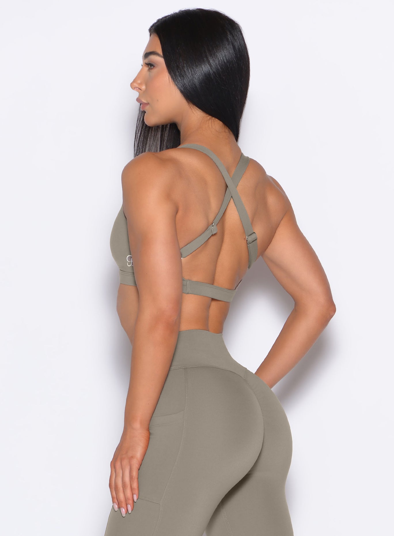 Back left side profile view of our model wearing the Sweetheart Sports Bra in Stone color