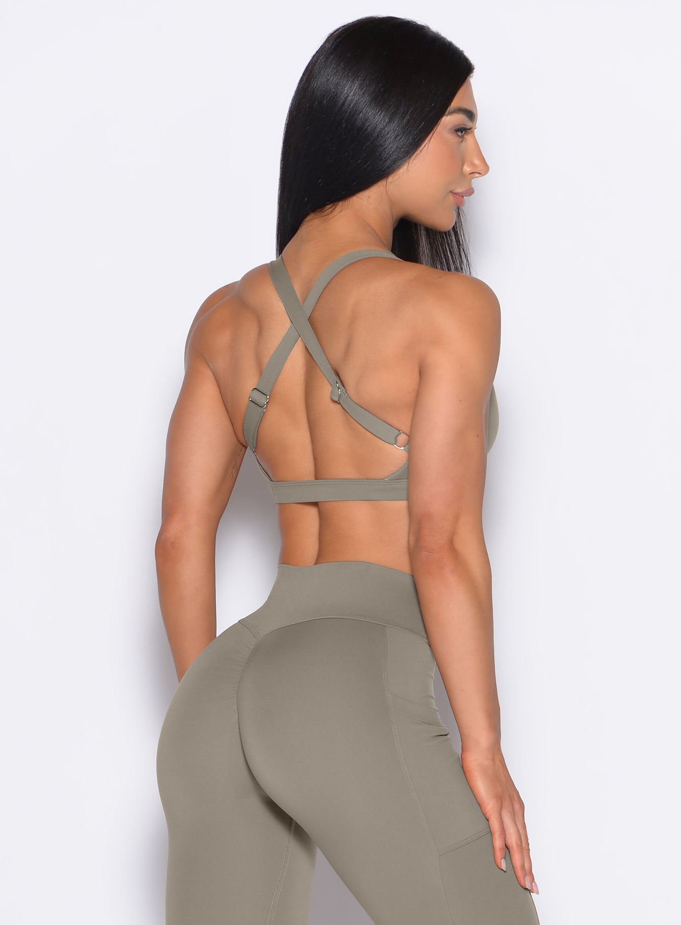 Back profile view of our model wearing the Sweetheart Sports Bra in Stone color