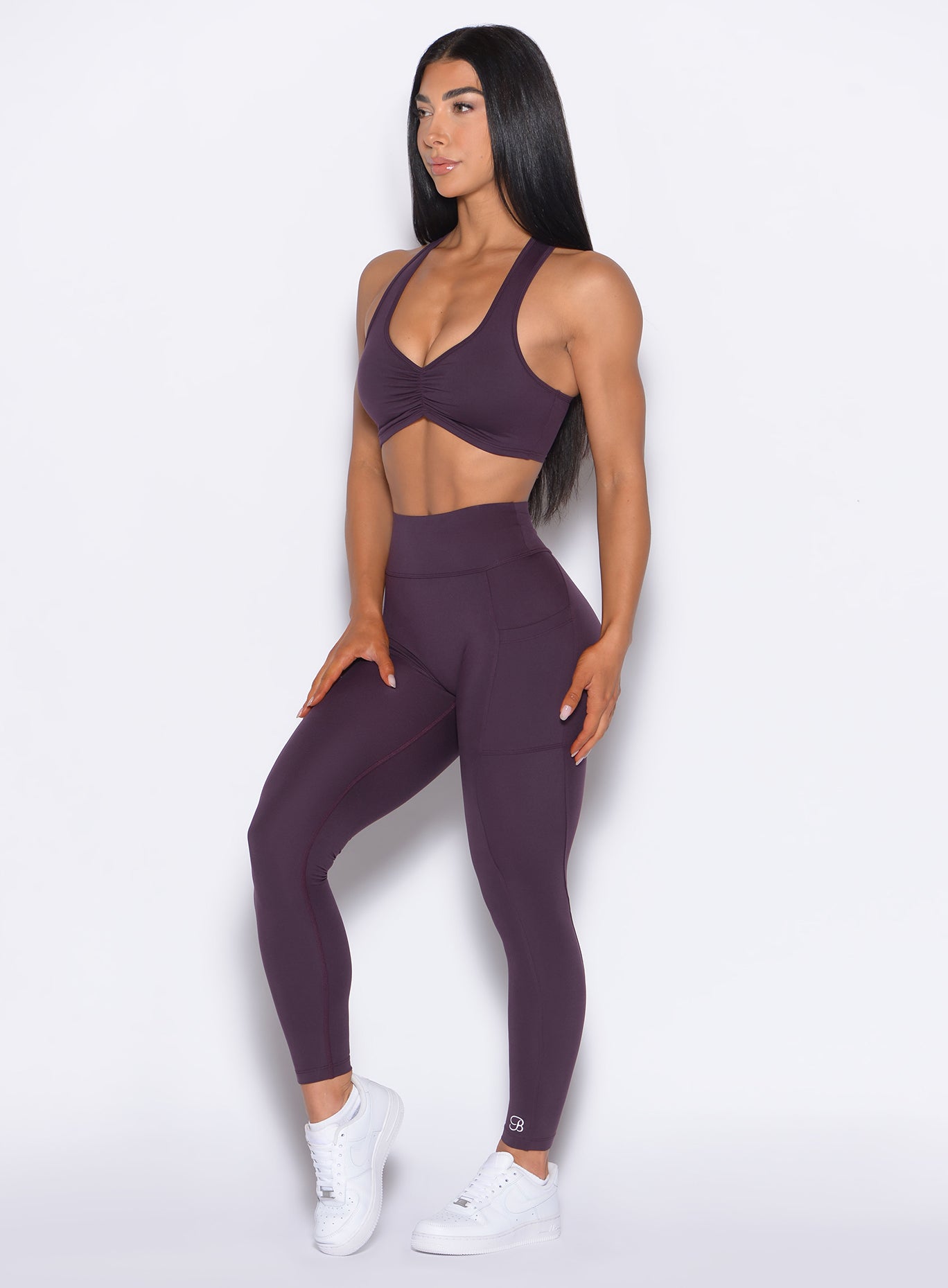 front left side profile view of our model wearing the Define Leggings in Plum Noir color