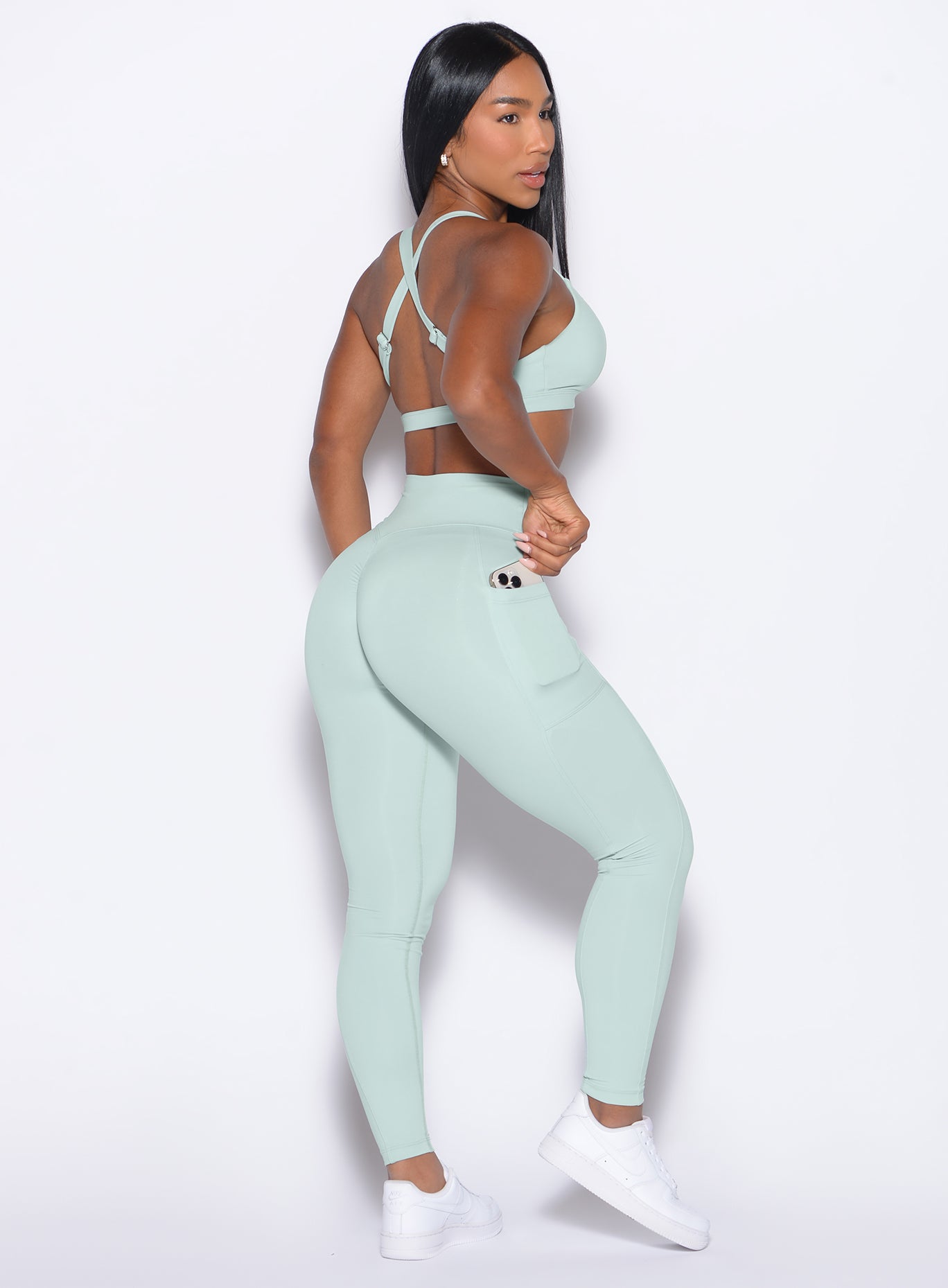 right side profile view of our model wearing the Define Leggings in Mist color