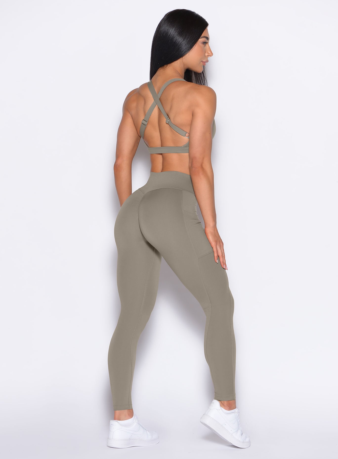 Back right side profile view of our model wearing the Define Leggings in Stone color