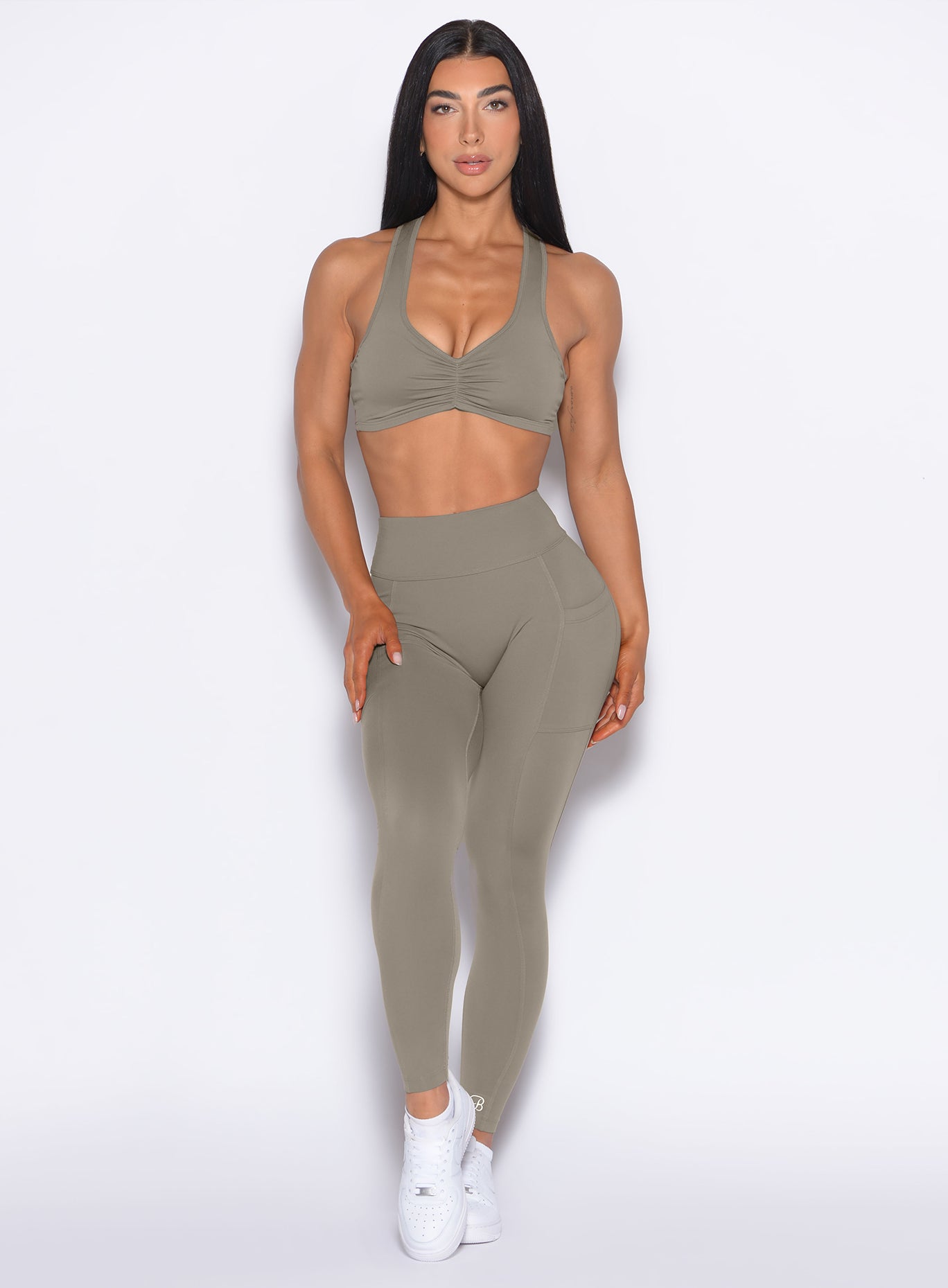 Front profile view of our model wearing the Define Leggings in Stone color