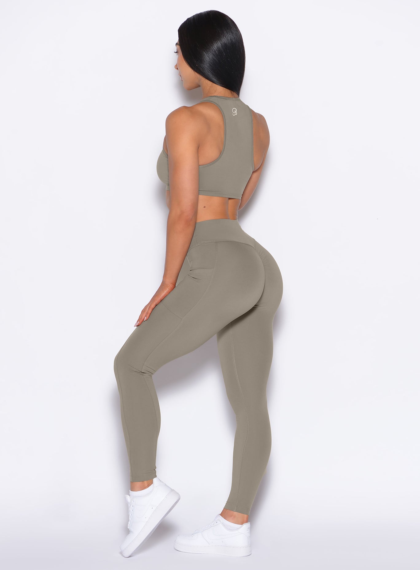 Back left side profile view of our model wearing the Define Leggings in Stone color