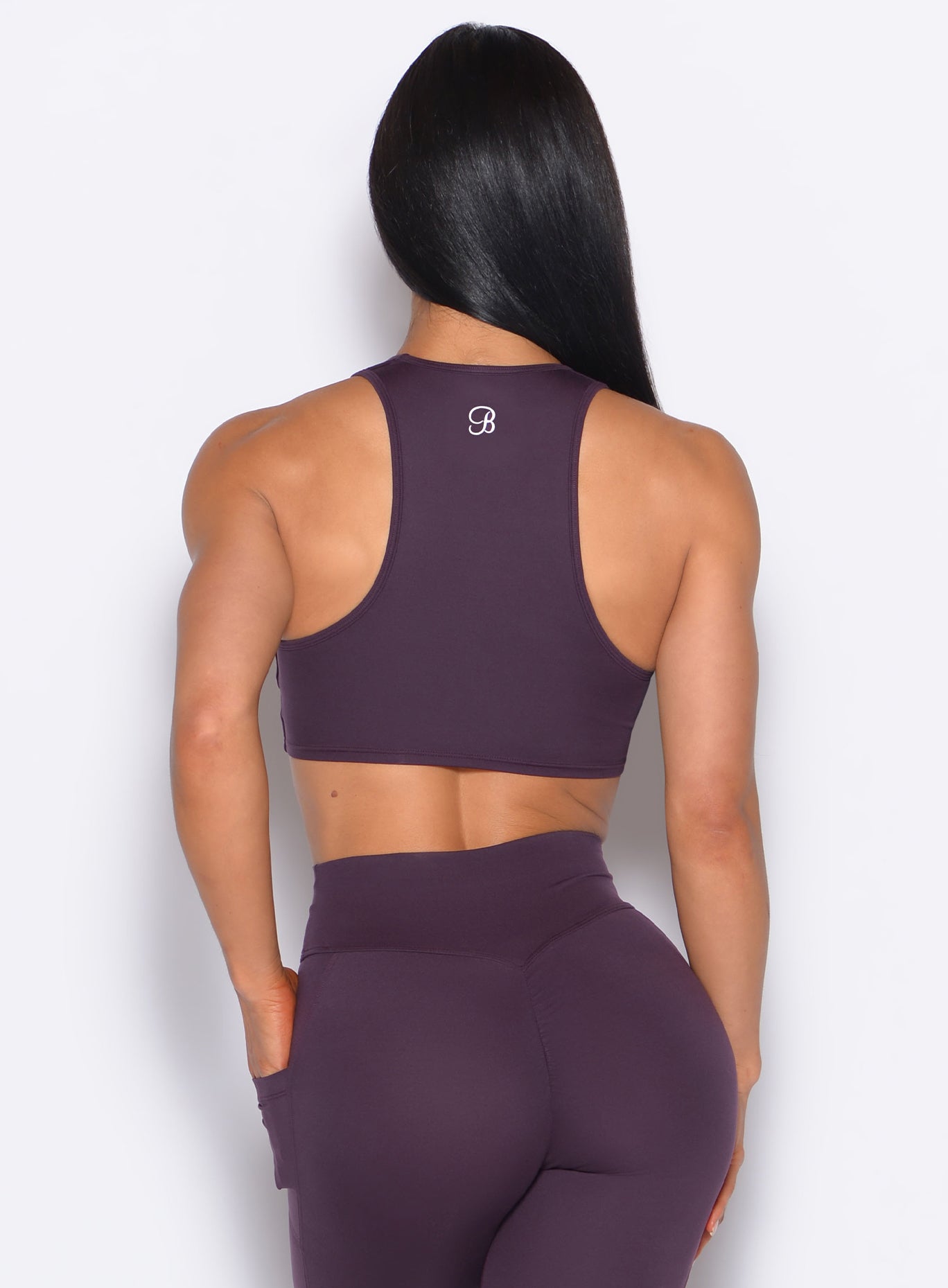 Back profile view of our model wearing the Scrunch Tank Bra in Plum Noir color