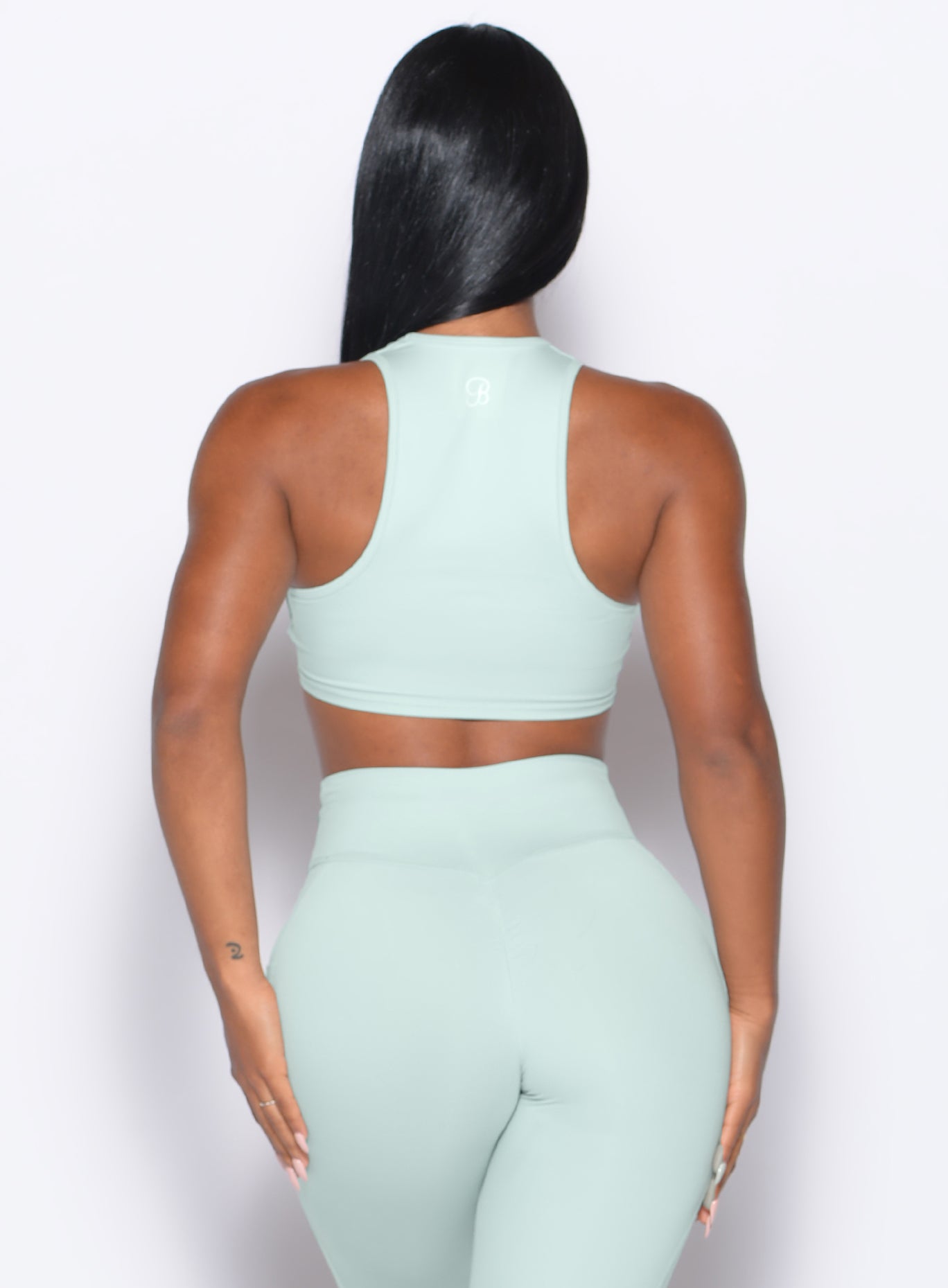 Back profile view of our model wearing the Scrunch Tank Bra in Mist color