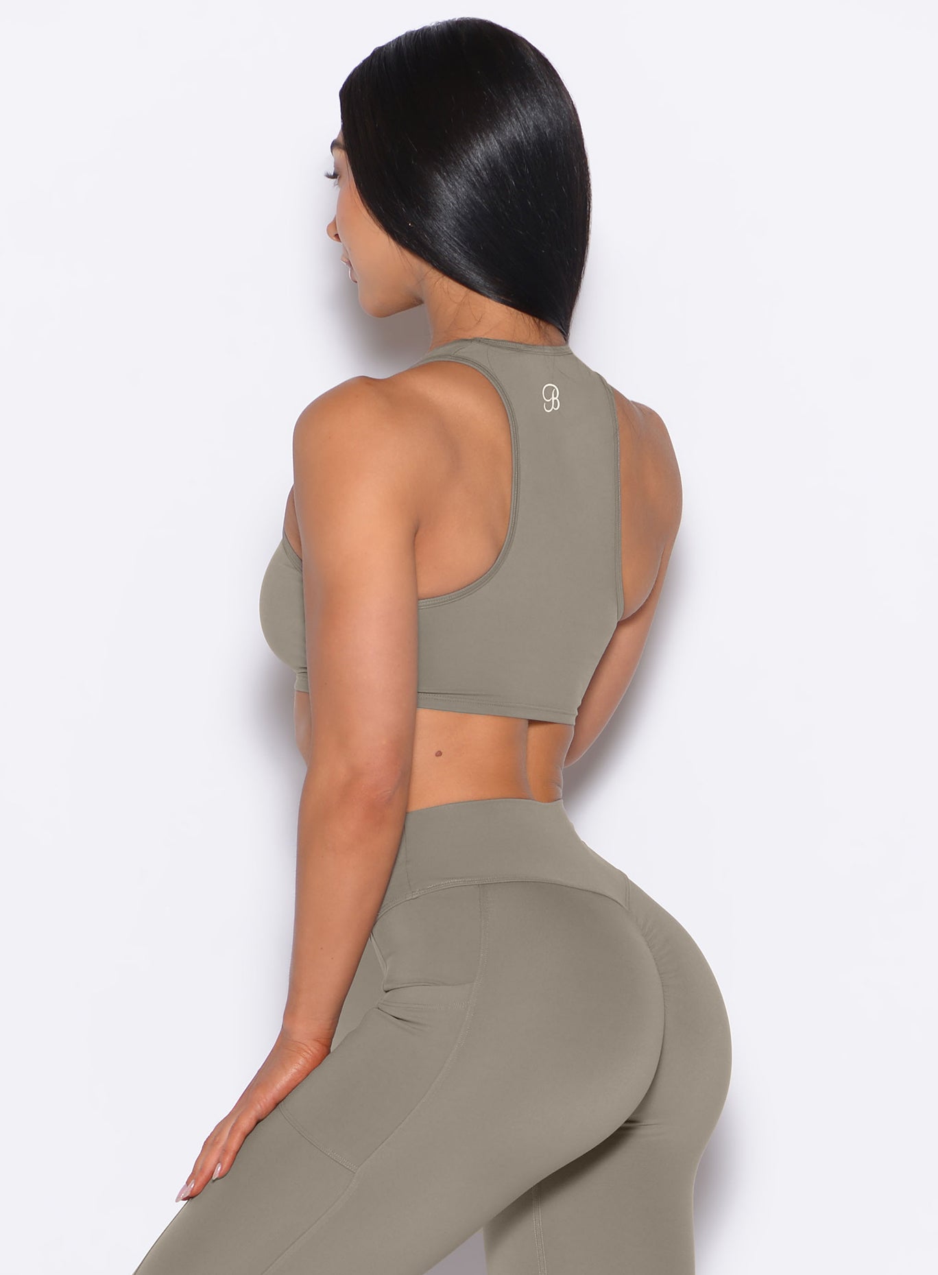 Back left side profile view of our model wearing the Scrunch Tank Bra in Stone color