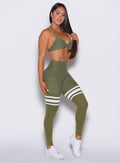 Right side view of a model facing to her right wearing our Scrunch Thigh-Highs and the matching bra in Lily Pad color
