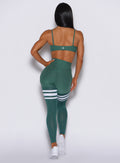 Back profile view of a model wearing our scrunch thigh high in Emerald Green along with a matching bra