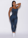 Front profile view of a model in our Sculpt Bodysuit in Vintage blue color