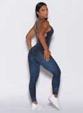 Right side profile view of a model in our Sculpt Bodysuit in Vintage blue color