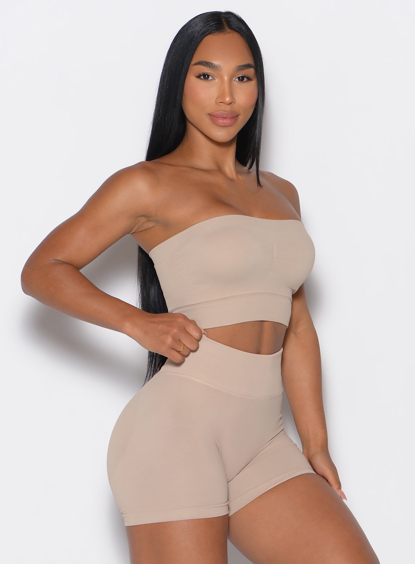 eight side profile view of a model wearing our seamless bandeau in timeless taupe color along with the matching shorts