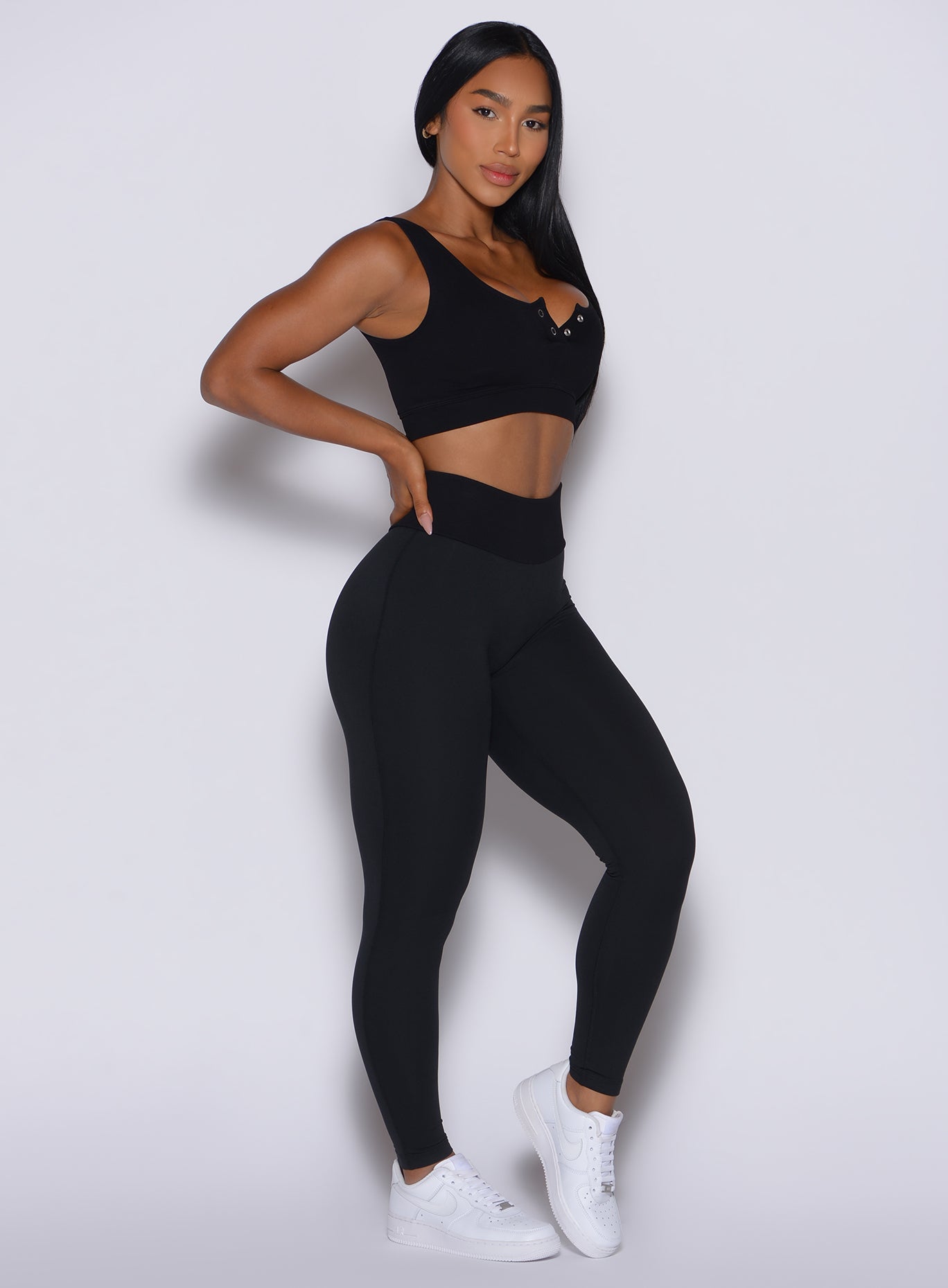 Front right side profile view of our model wearing the Figure Leggings in Black color