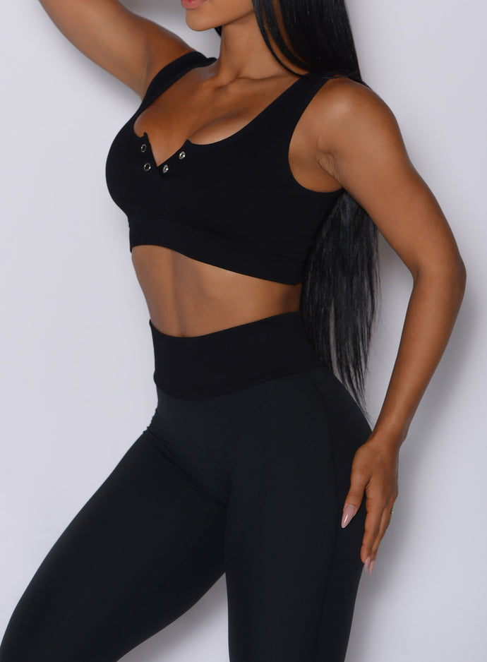 Close up front left side profile view of our model wearing the Figure Leggings in Black color