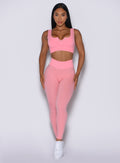 Front profile view of our model wearing the Figure Leggings in Peach Burst color