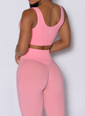 Close up back profile view of our model wearing the Figure Leggings in Peach Burst color