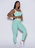 Front right side profile view of our model wearing the Figure Leggings in Spring Mint color