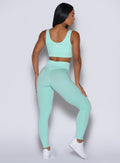 Back profile shot of our model facing to the right wearing the Figure Leggings in Spring Mint color