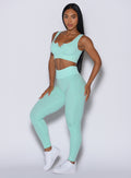 Front left side profile view of our model wearing the Figure Leggings in Spring Mint color