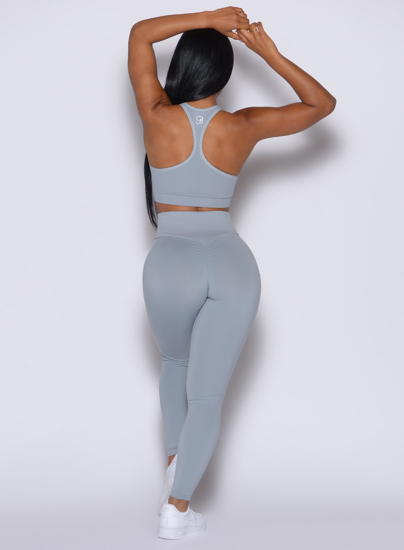 Back profile view of our model wearing the Figure Scrunch Leggings in Carbon color