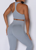 Close up back profile view of our model wearing the Figure Scrunch Leggings in Carbon color