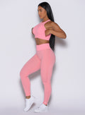 Left side profile view of our model wearing the Figure Scrunch Leggings in Peach Burst color