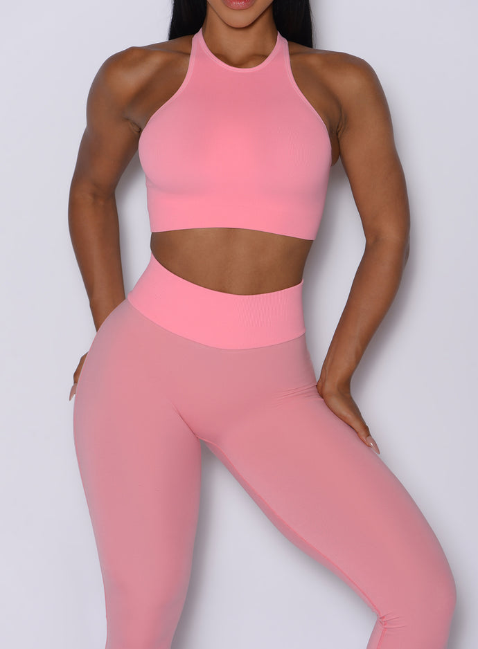 Close up front profile view of our model wearing the Figure Scrunch Leggings in Peach Burst color