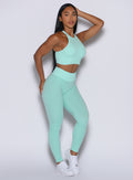 Front left side profile view of our model wearing the Figure Scrunch Leggings in Spring Mint color