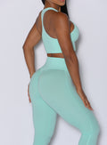 Close up right side profile view of our model wearing the Figure Scrunch Leggings in Spring Mint color